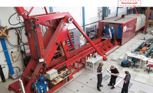 The two-storey bright red "Kicking Machine" is so powerful it needs a 150 000 tonne reaction wall behind it to absorb the force of its blow. Photo. SIMLab