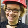 Portrait of a woman with a red helmet.