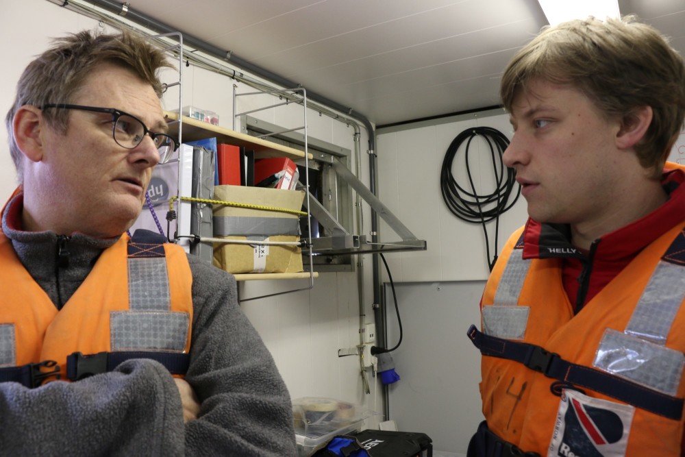 Geir Johnsen, left, a professor in marine biology at NTNU, talks with his master's student, John Kjeken, about the cold-water coral reefs they have seen growing on old WWII bombs. Photo: Nancy Bazilchuk