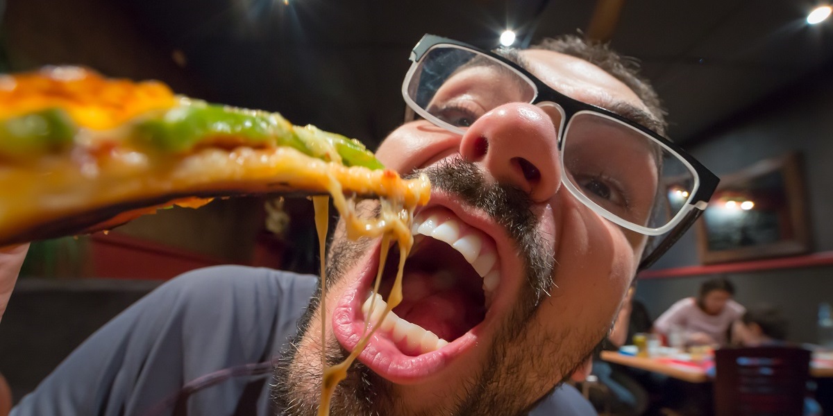 Man eating pizza in a restaurant