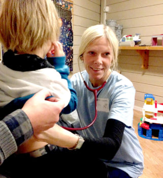 Paediatrician and PhD candidate Nina Moe examines a child and collects nasal mucus sample as part of respiratory virus study. Photo: NTNU