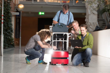 Some of the research participants demonstrate how the cyborg works. From left to right are PhD candidate Peter Aaser, ITK Associate Professor Sverre Hendseth, PhD candidate Martinius Knudsen and master’s student Jorgen Walo. Photo: Kai T. Dragland, NTNU