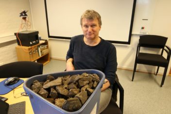 Geir Grønnesby, an archaeologist at the NTNU University Museum, has buckets full of rocks that have been used to brew beer since the Viking age. They're found in buried rubbish heaps around many farms in Trøndelag. Photo: Nancy Bazilchuk