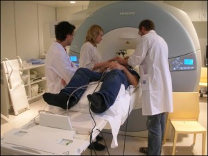Doctors and nurses check up on a patient in an MRI machine