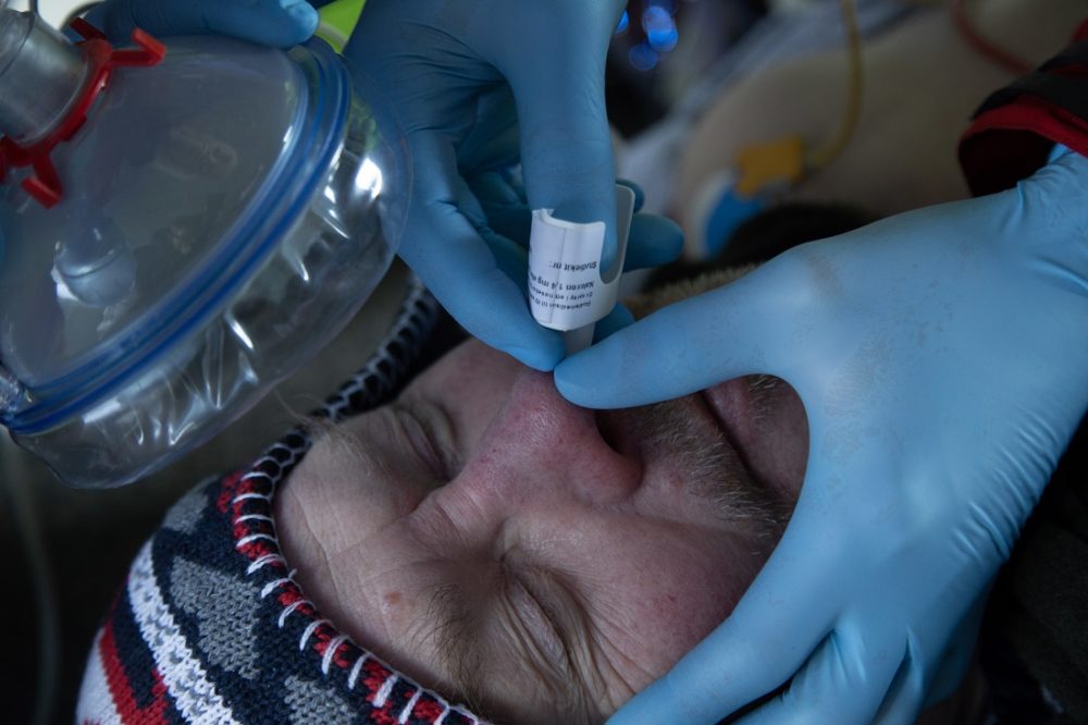 A wounded man recieving Naloxone nasa lspray