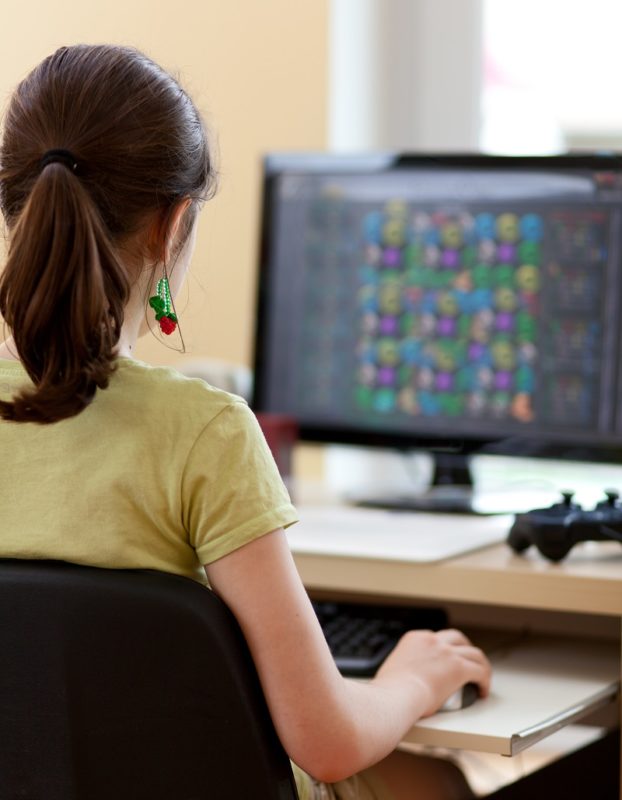 A girl playing a video game on a computer