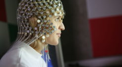 A lady with lots of electrical equipment on her head