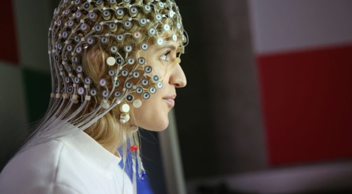 A lady with lots of electrical equipment on her head