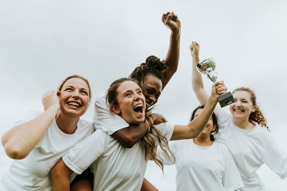 Equality. The photo shows female athletes celebrating.