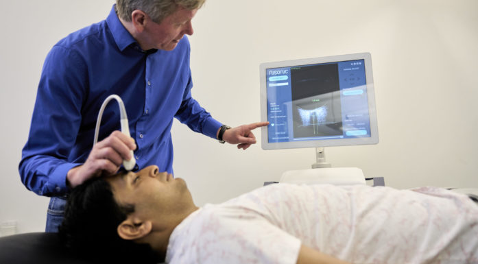 Researcher demonstrating a new ultrasound device for detecting brain pressure