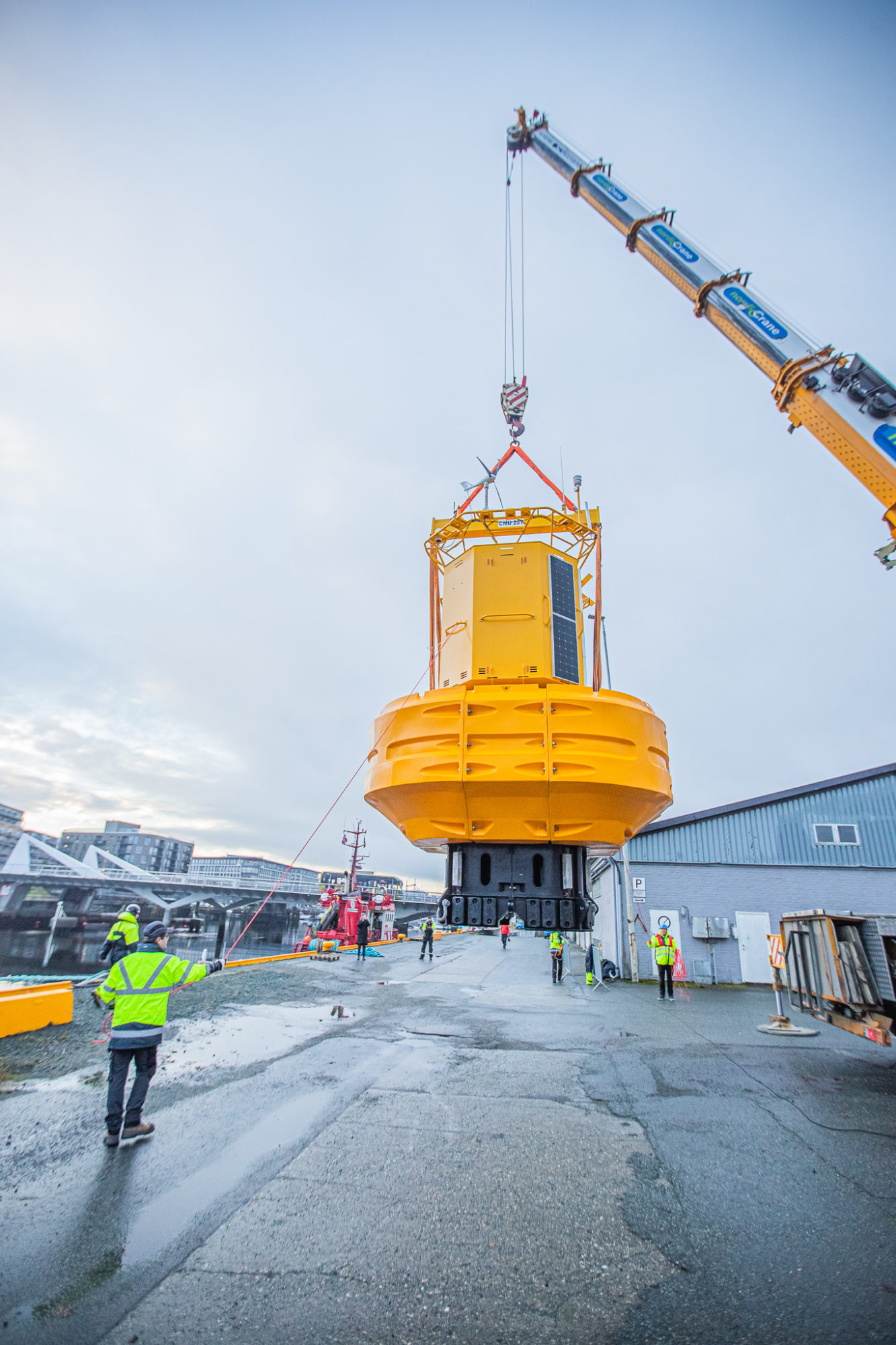 One of the research buoys is being loaded onto the tugboat
