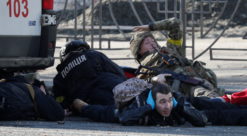 People take cover as an air-raid siren sounds in Kyiv