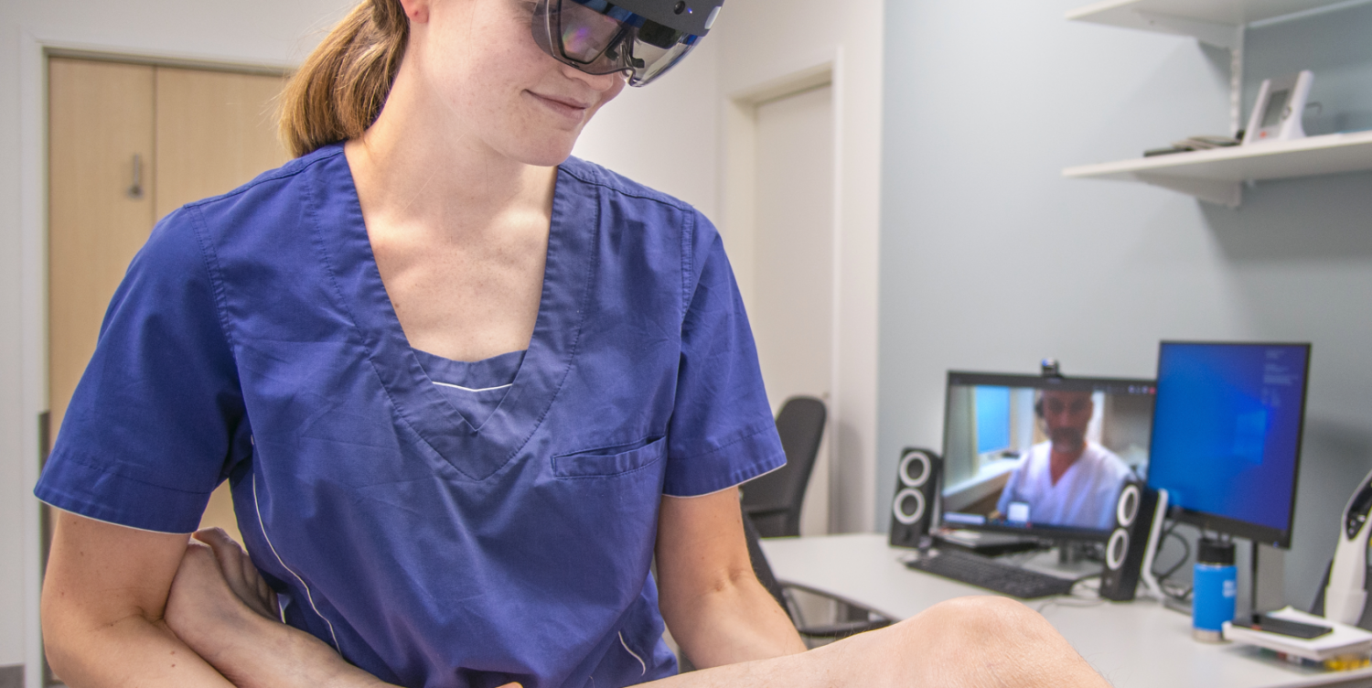 Physiotherapist Anna Osen Byberg (wearing a HoloLens augmented reality headset) seen here working with orthopaedist Ivar Hanssen at Helgeland Hospital. Hanssen can both observe the patient and instruct the physiotherapist in real time. Photo courtesy of Helgeland Hospital Trust
