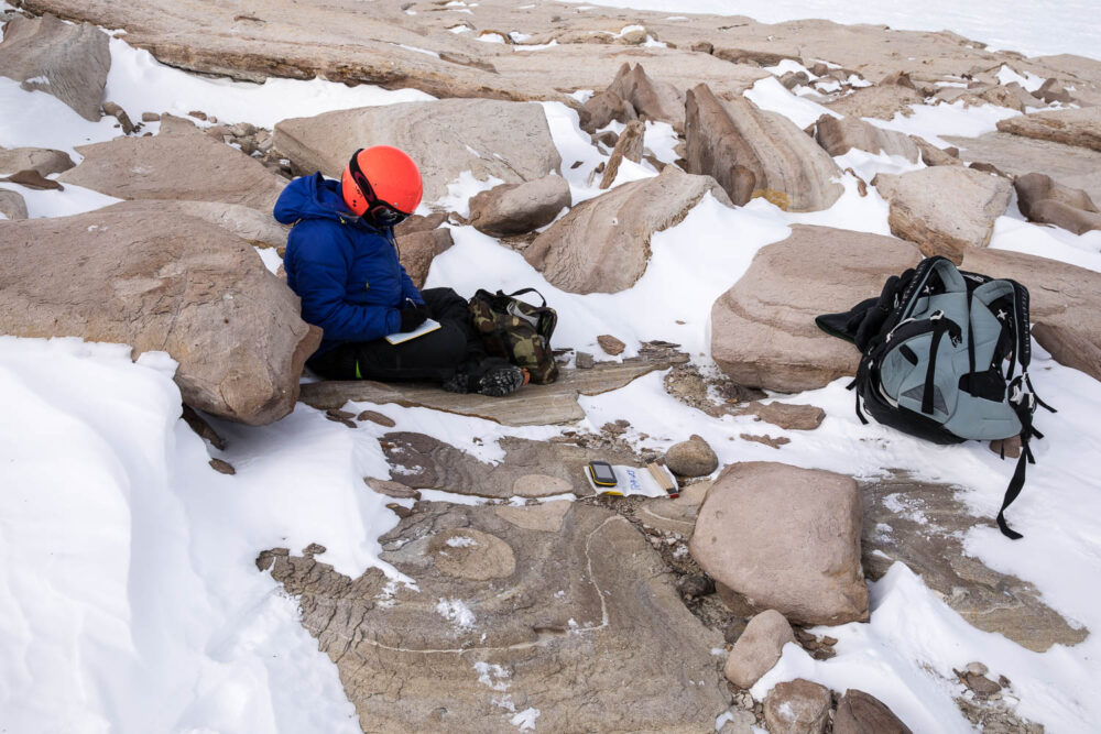 Antarctica, field work. Researcher collecting stones for cosmogenic isotope analysis.