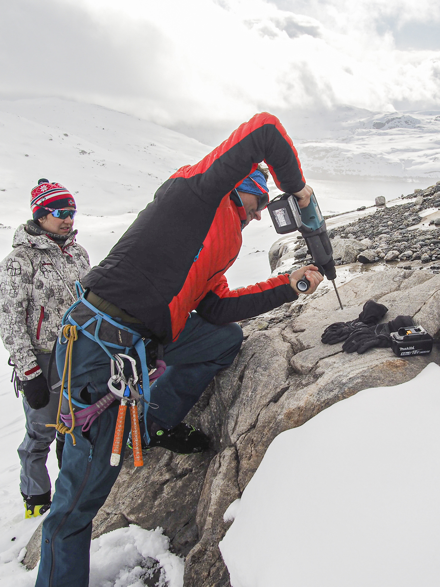 A group of researchers wants to help communities living close to melting glaciers. Photo shows scientists mounting equipment on a rock.