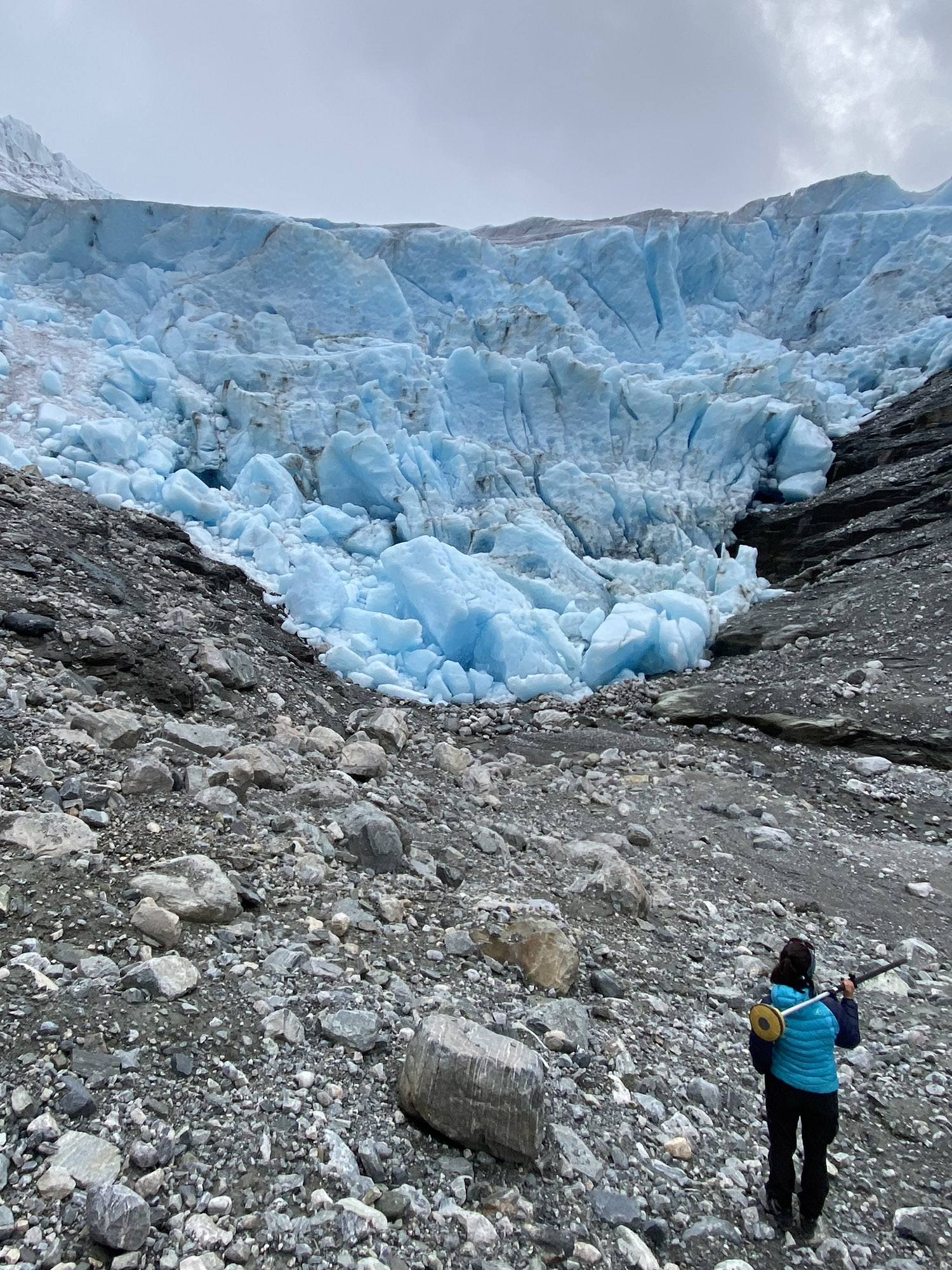 Person standing in front of glacier