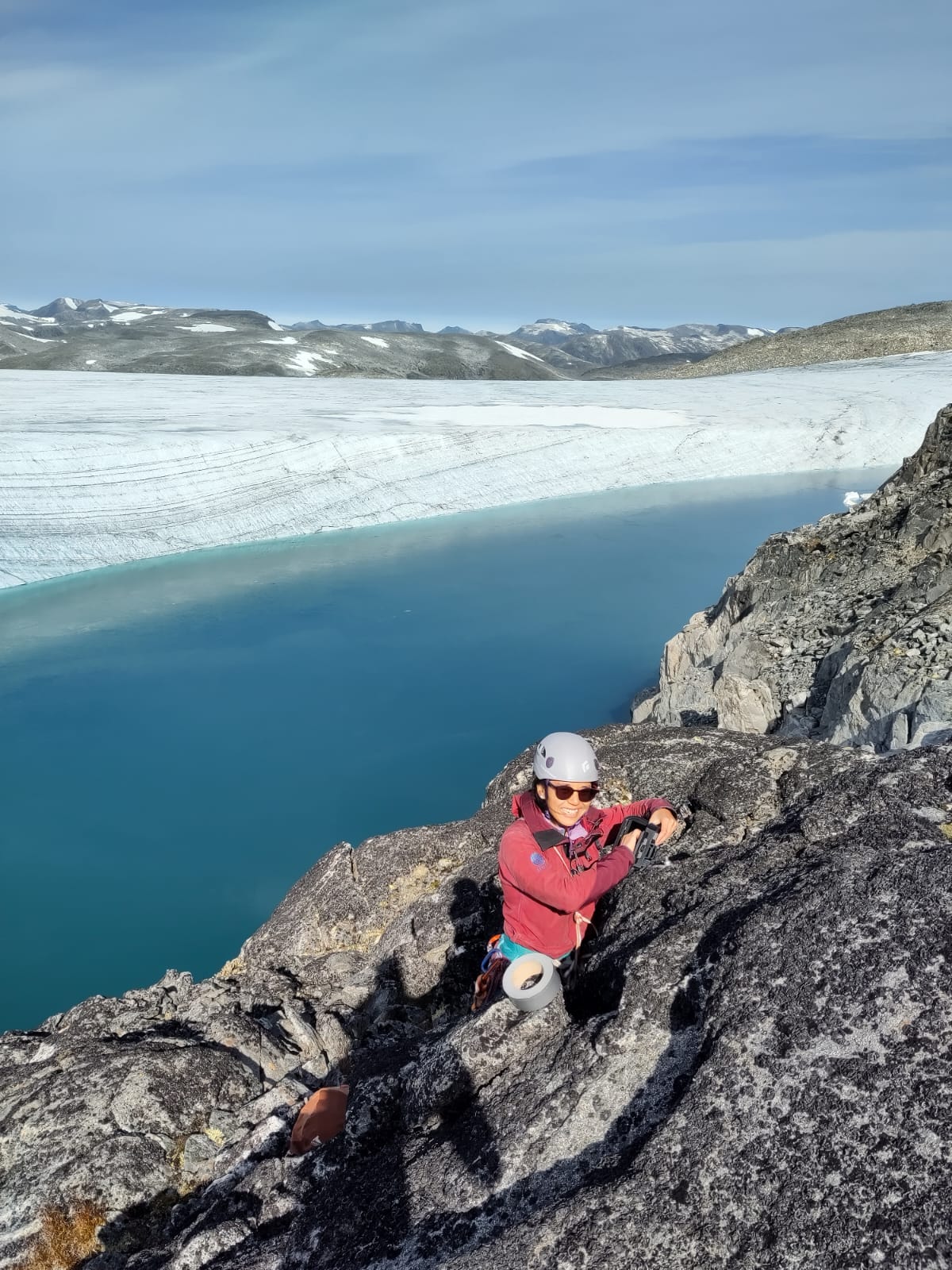 A group of researchers wants to help communities living close to melting glaciers. Photo shows a female scientist mounting equipment.