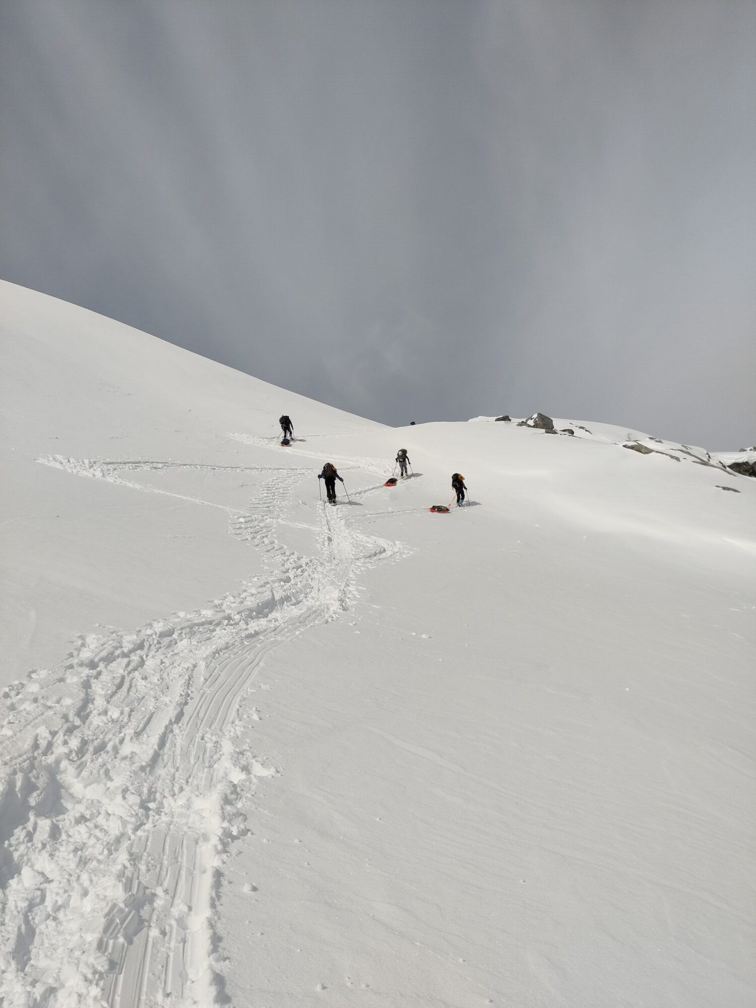 A group of researchers wants to help communities living close to melting glaciers. Photo shows scientists skiing on a glacier.