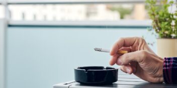 Smokers. Photo shows a hand with a cigarette.