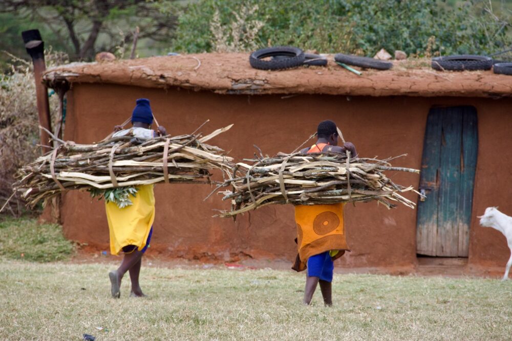 Women collect firewood in Kenya.