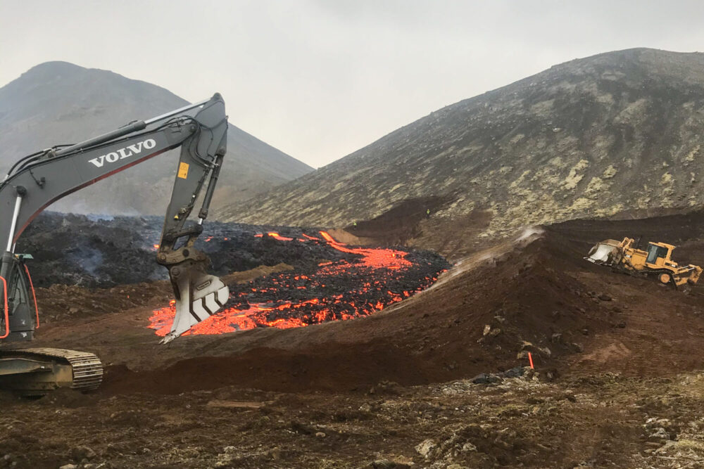 Earthen dam being built to control lava flow