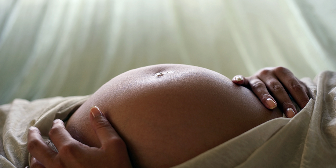 Pregnant woman's belly. Photo.