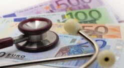 A stethoscope on top of a pile of Euro bills.Photo.