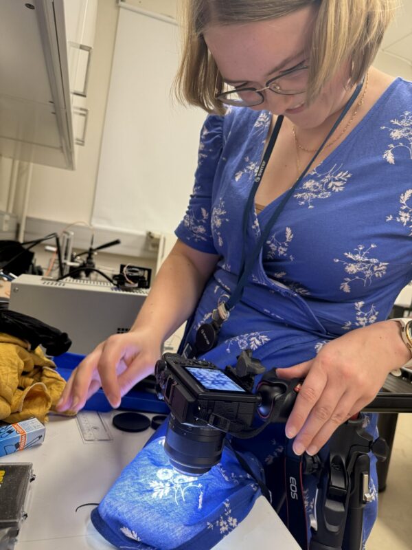 Doctoral fellow Vilde Vraalstad takes a picture of her own dress with an early version of the camera setup.