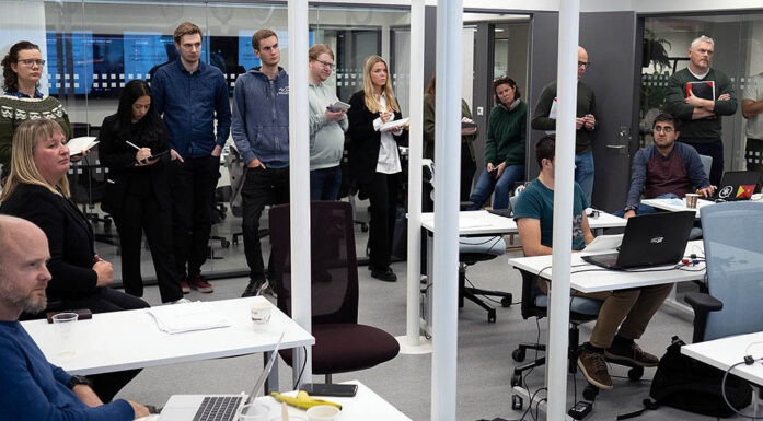 Room full of people participating in a cyber security exercise. Photo.