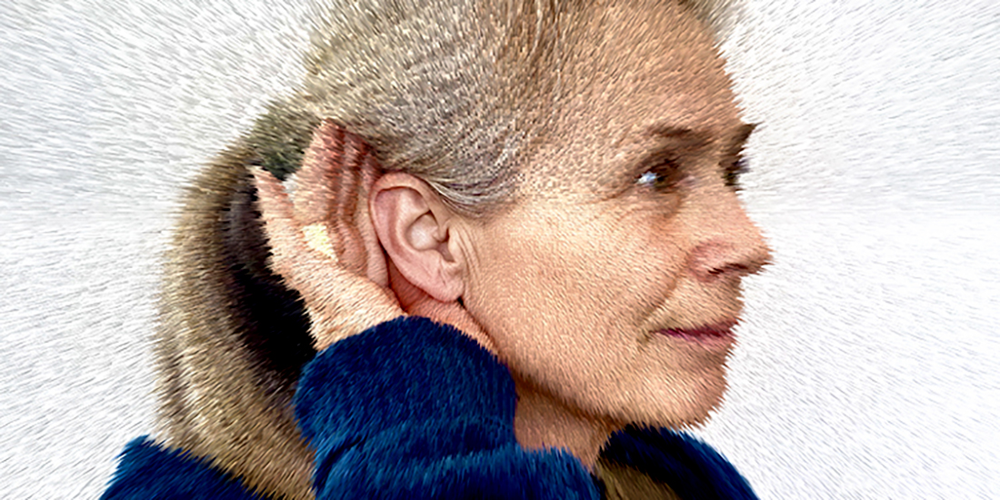 Woman with her hand cupping her ear to improve hearing. Photo illustration.