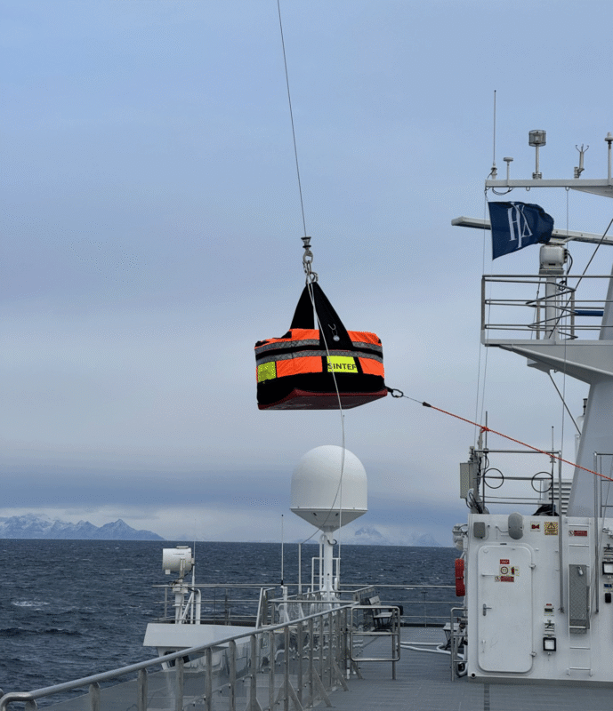 Bag with towing equipment is lowered onto the deck.