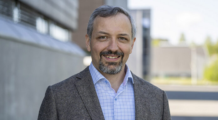 portraits of professor in grey jacket outside