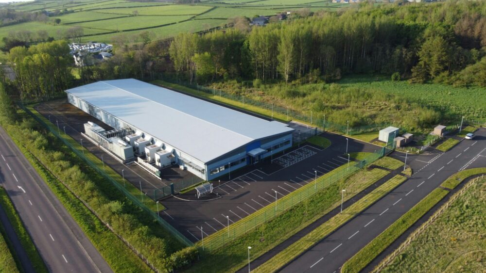 a data centre in a green landscape, pictured from above.