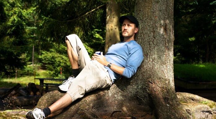 sitting and feeling content under a tree