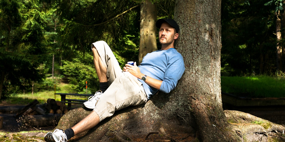 sitting and feeling content under a tree