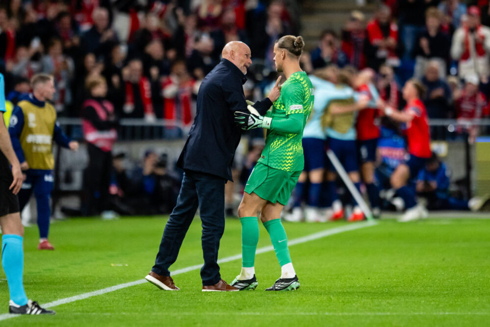 football manager remonstrating with goalkeeper