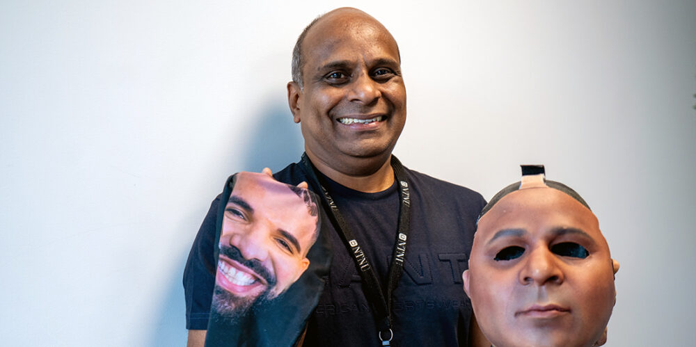 Professor Raghavendra Ramachandra posing with two masks 