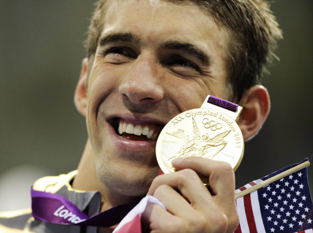 Michael Phelps and one of his gold medals from London Olympics